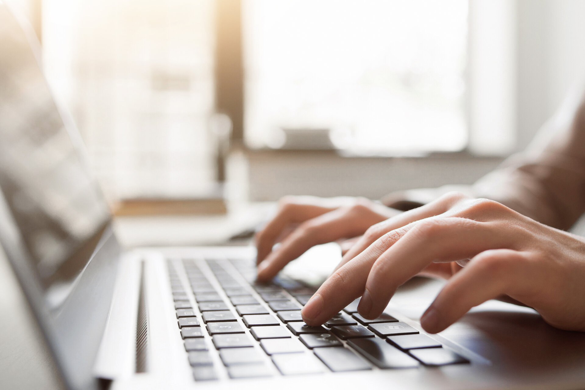 Woman typing on a laptop